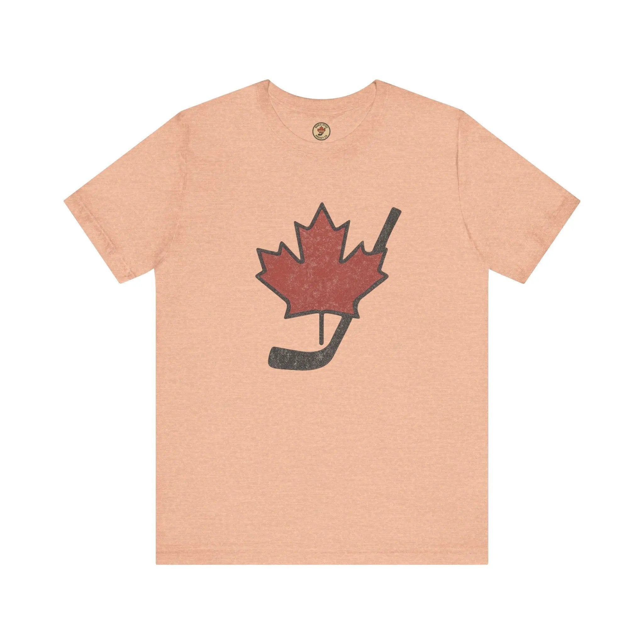 Beige T-shirt with maple leaf and hockey stick graphic on front on white background
