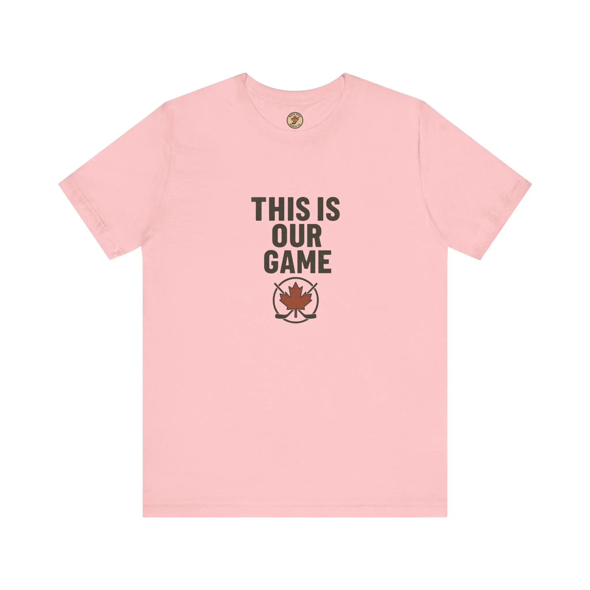 Pink women's T-shirt with 'This Is Our Game' text and maple leaf graphic on a white background