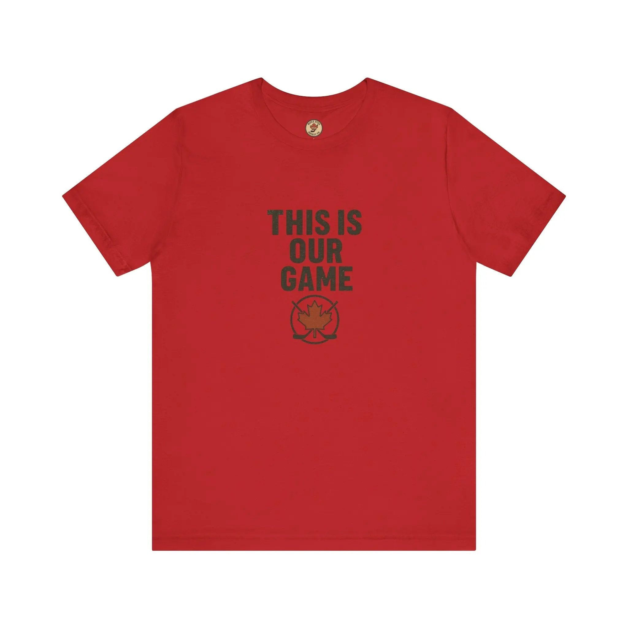Red women's T-shirt with 'This Is Our Game' text and maple leaf graphic on a white background