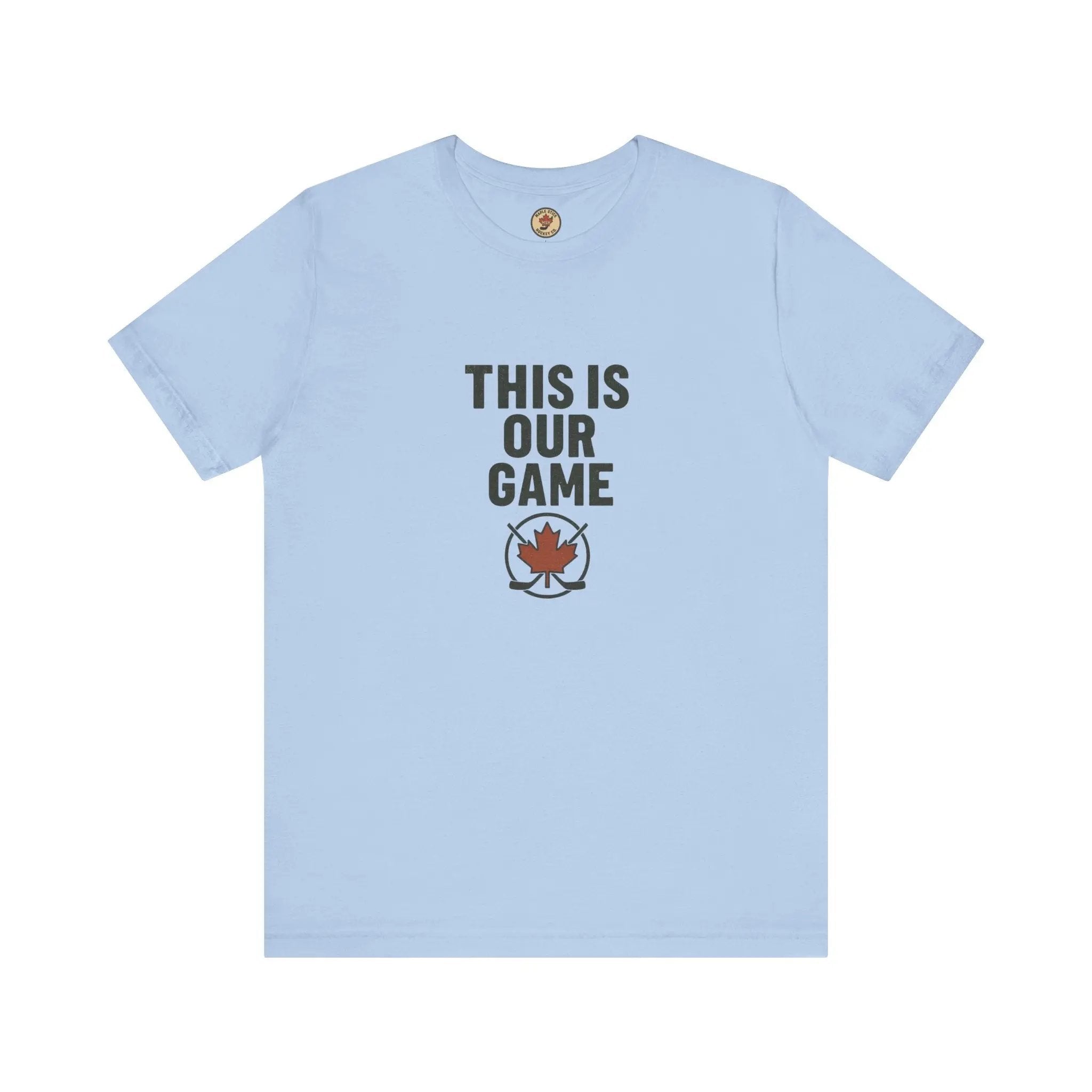 Light blue women’s T-shirt with ‘This Is Our Game’ text and maple leaf graphic – Maple Stick Hockey product.