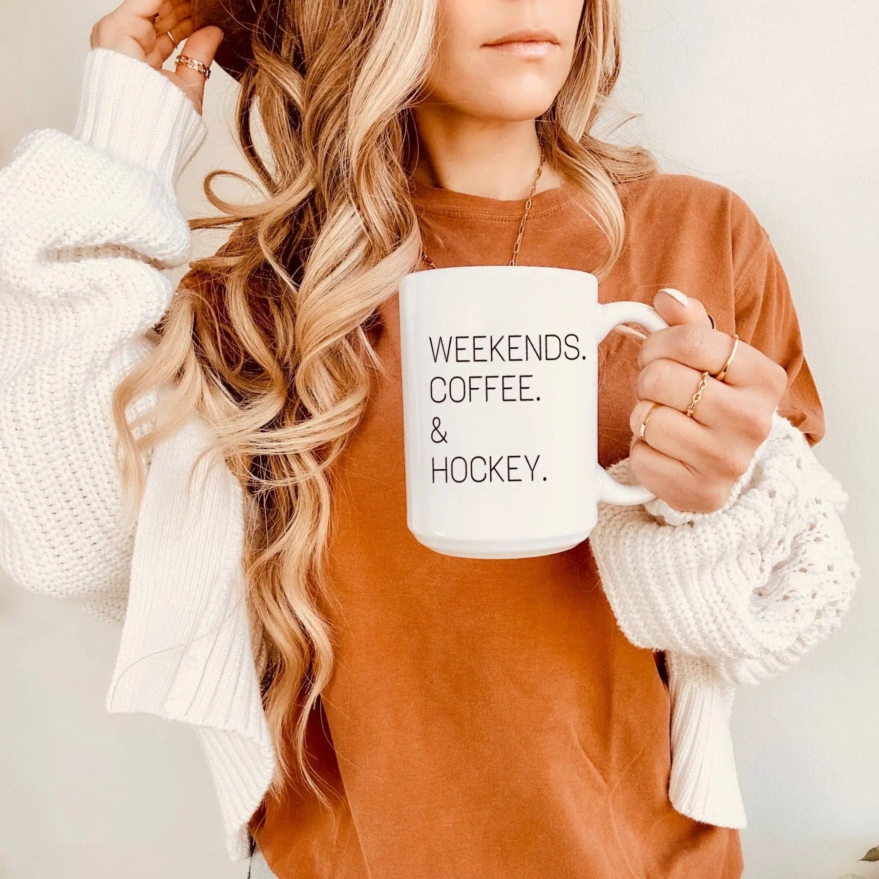 Woman holding a white ceramic mug printed with 'Weekends Coffee & Hockey', Rustic Girls product